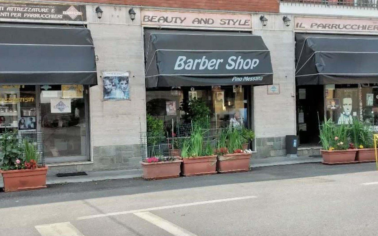 Vetrina di Beauty and Style in Via Rivette con tenda Barber Shop Pino Messana e fioriere